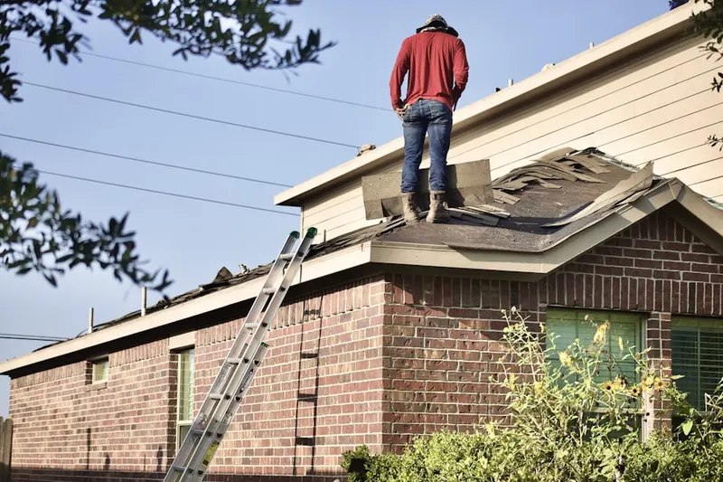Professional roofer working on a residential roof in Quince Orchard Manor